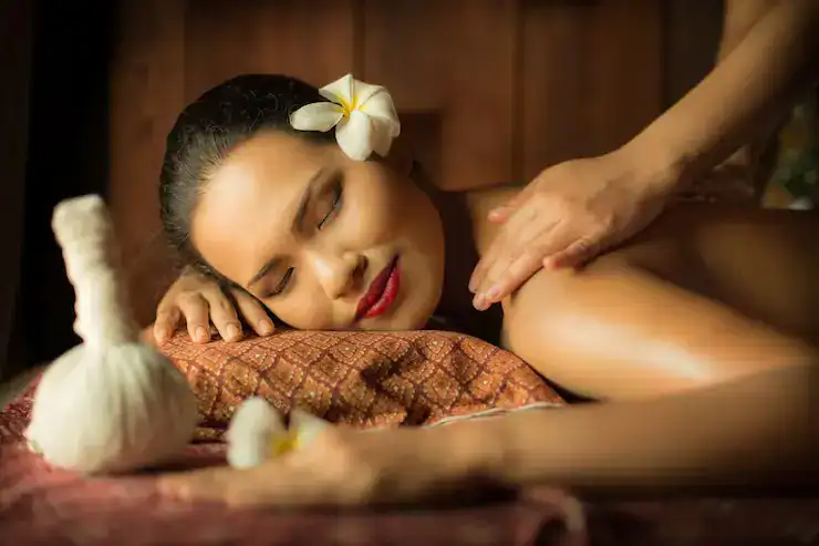 Relaxing Kerala spa massage with woman enjoying traditional wellness treatment.