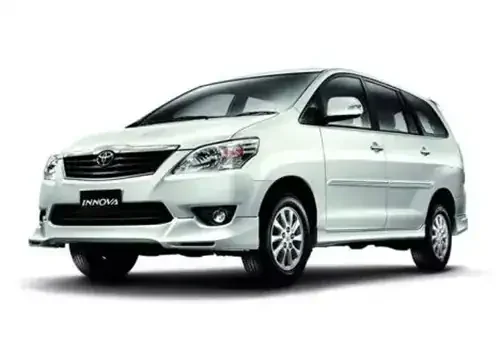White Toyota Innova car for Kerala taxi services.